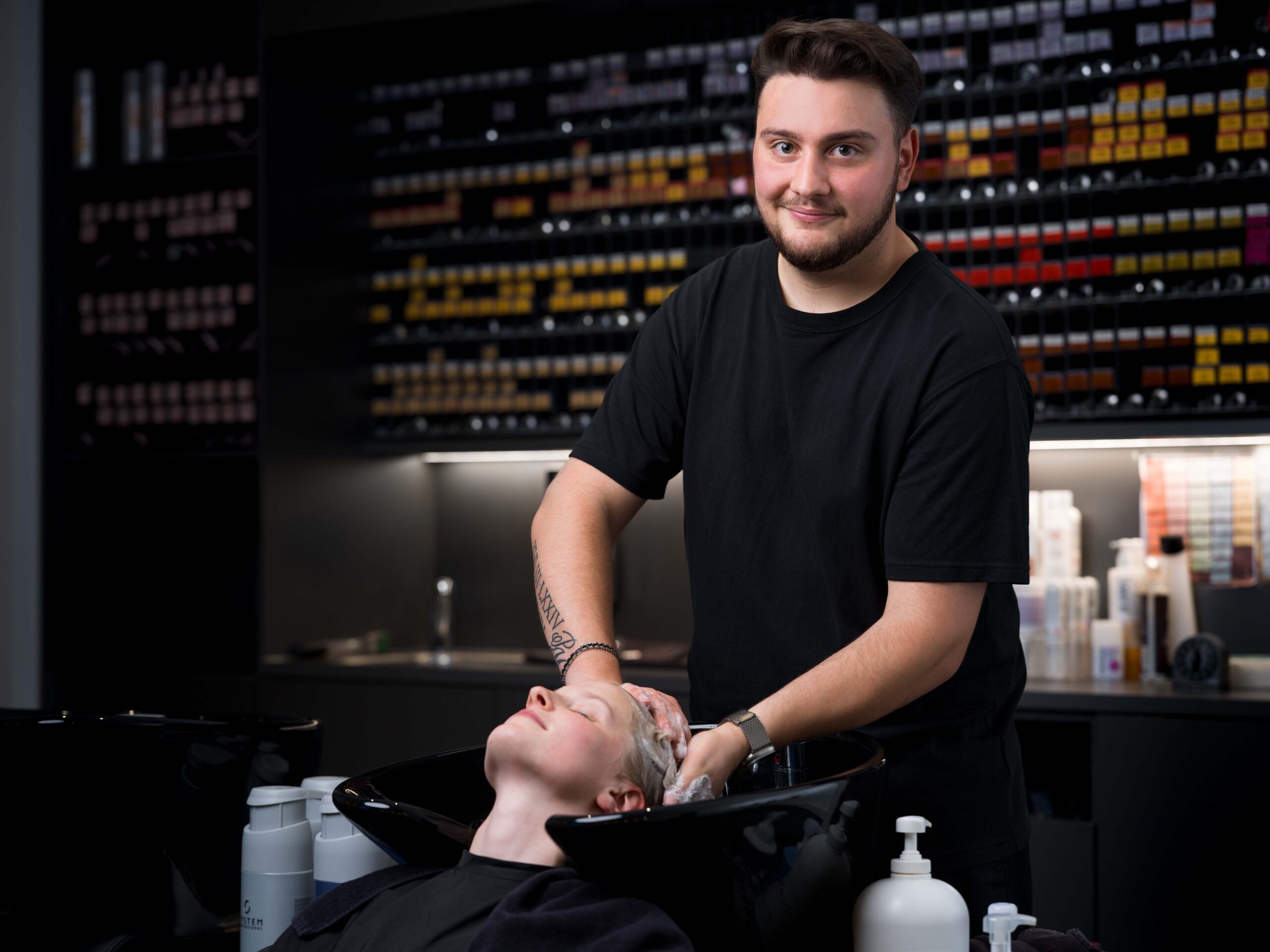 Friseur wäscht die Haare einer jungen Dame im Friseursalon Coroneo Hair Design